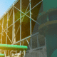 Exterior view of an industrial cooling tower structure with metal framework, green pipes, and a large pipe joint under sunlight—ideal for Case Studies on modern facility design.