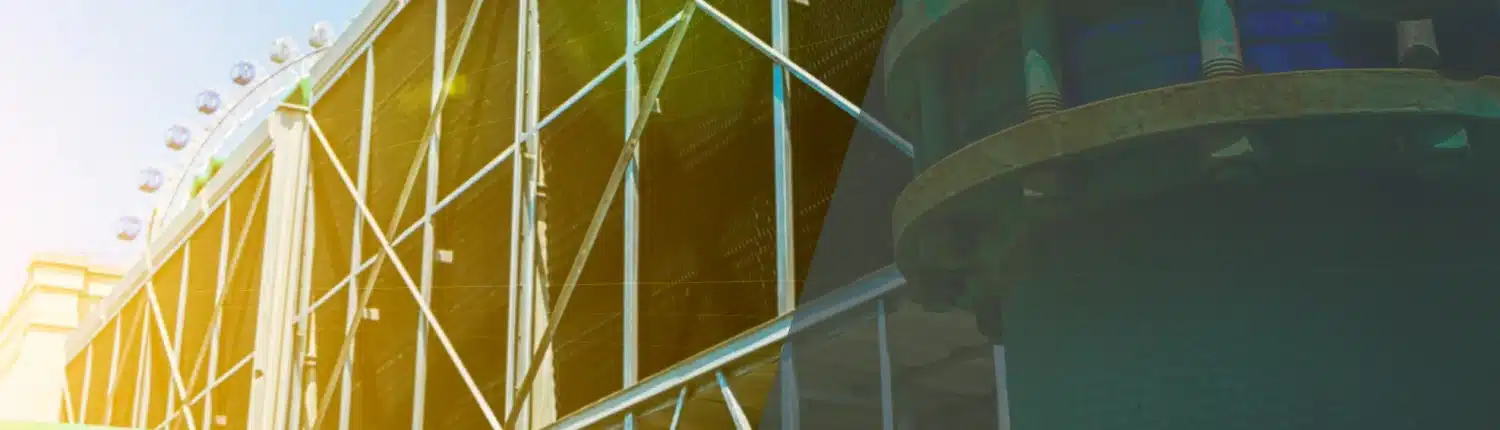 Large industrial pipes and a metal structure outside a building, with sunlight creating a lens flare effect across the image. The scene suggests an industrial or utility facility.