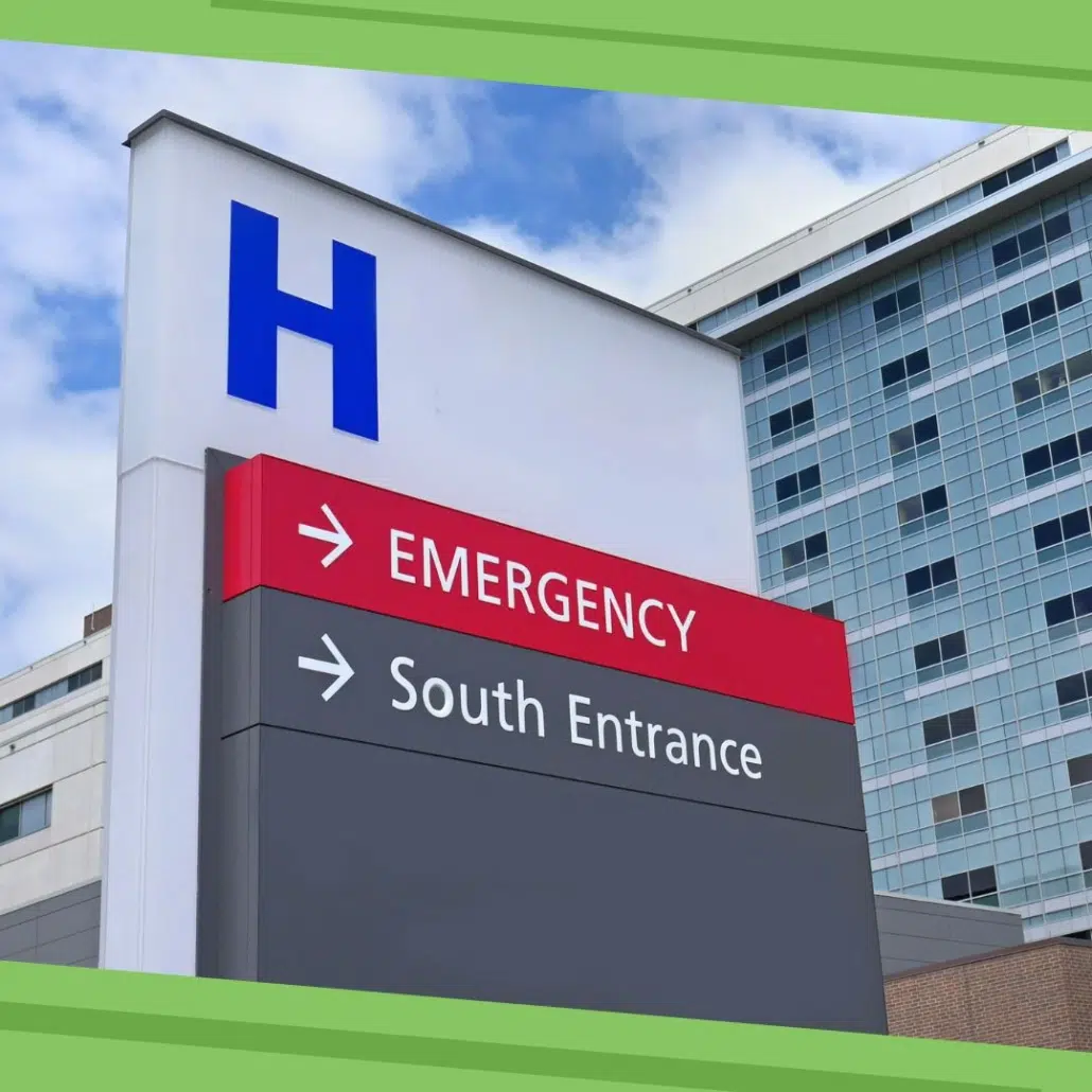 A hospital sign with a large blue H shows directions to the Emergency department and South Entrance, highlighting the importance of Legionella prevention and healthcare facility water management against a backdrop of a modern hospital building. A hospital sign with a large blue H shows directions to the Emergency department and South Entrance, highlighting the importance of Legionella prevention and healthcare facility water management against a backdrop of a modern hospital building.